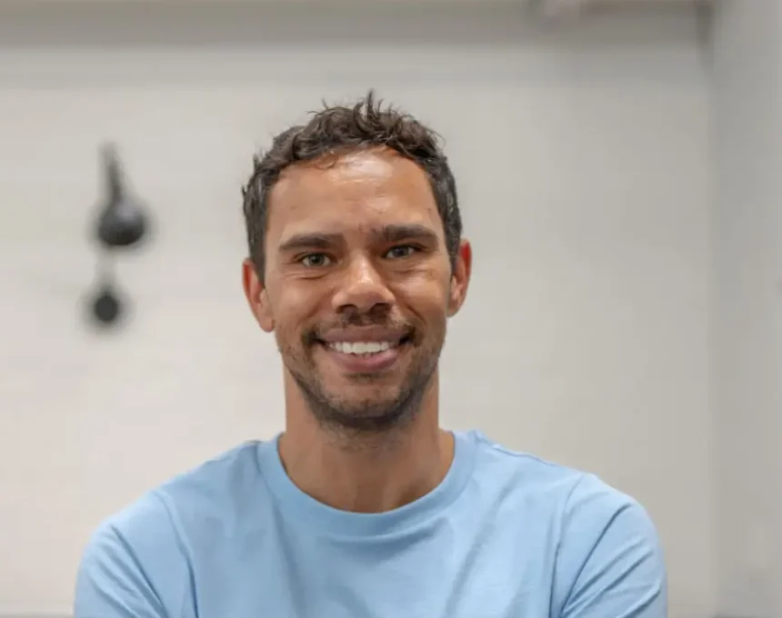 Smiling man in blue shirt shares positive experience at retirement community.