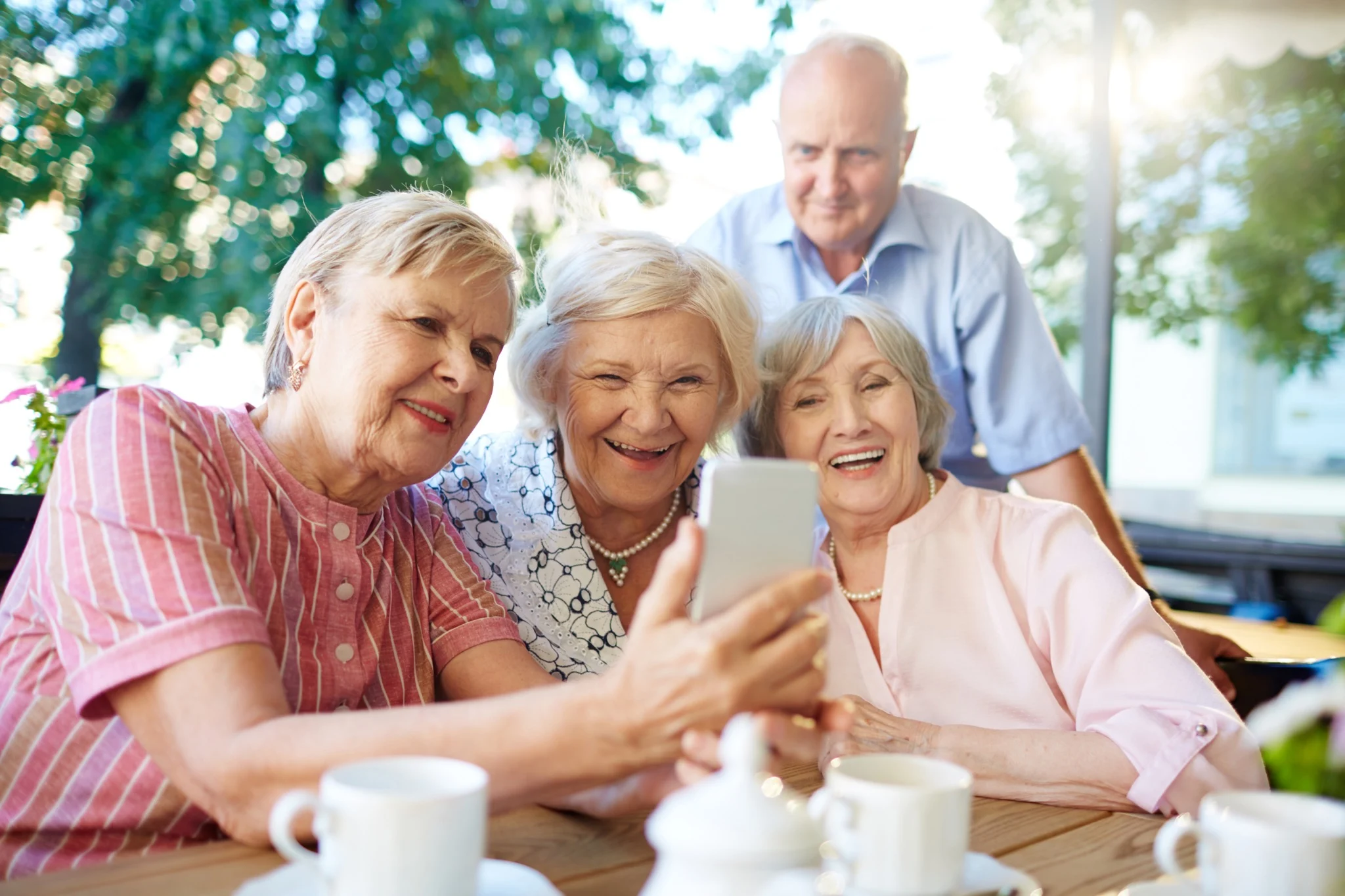 Senior couple discussing retirement living vs aged care options at home over a cup of tea