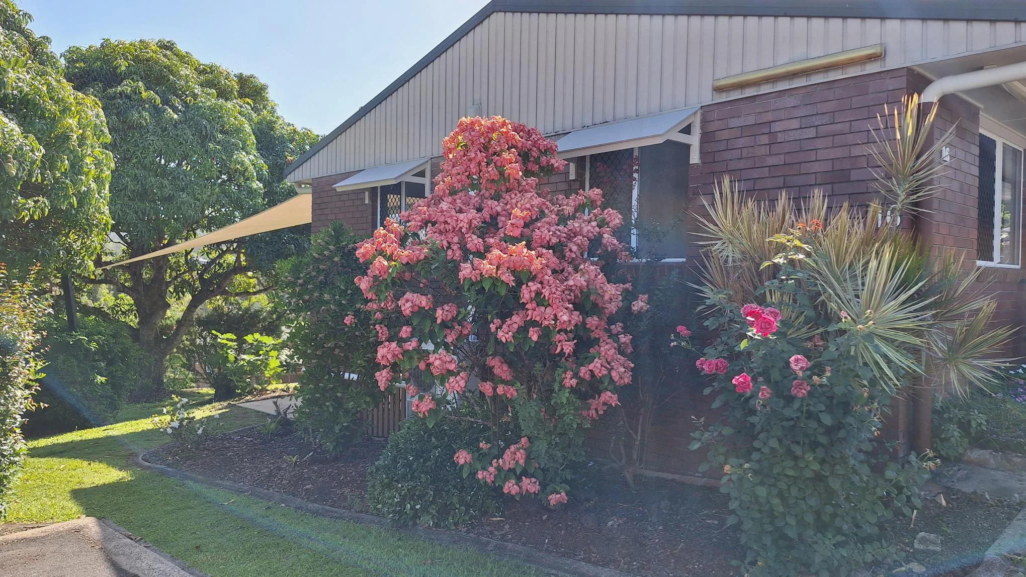 Elevated unit with vibrant flowers, offering peaceful living and space to unwind.