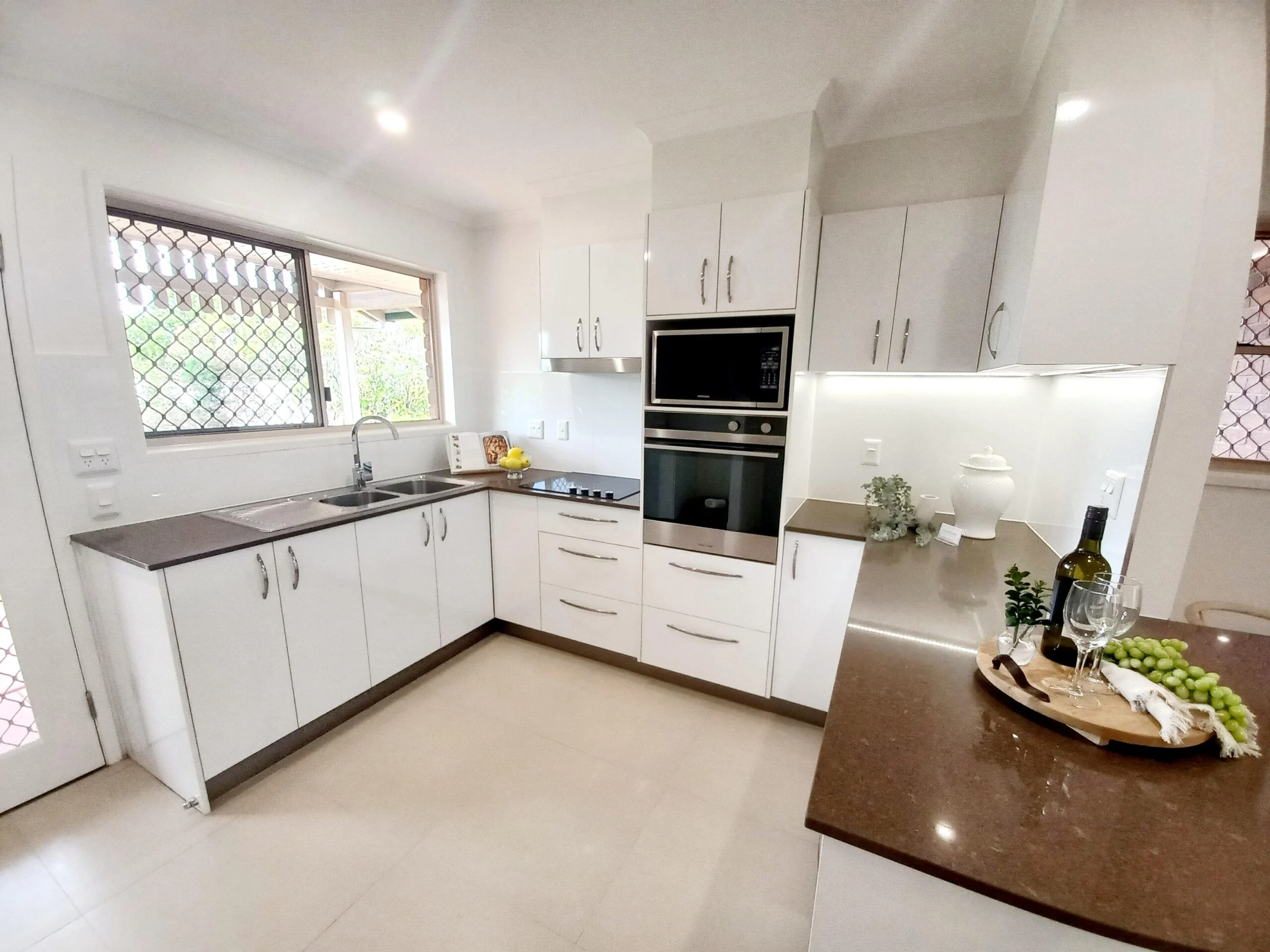 Light-filled kitchen in Sundale Retirement Community unit, showcasing modern appliances and inviting design.