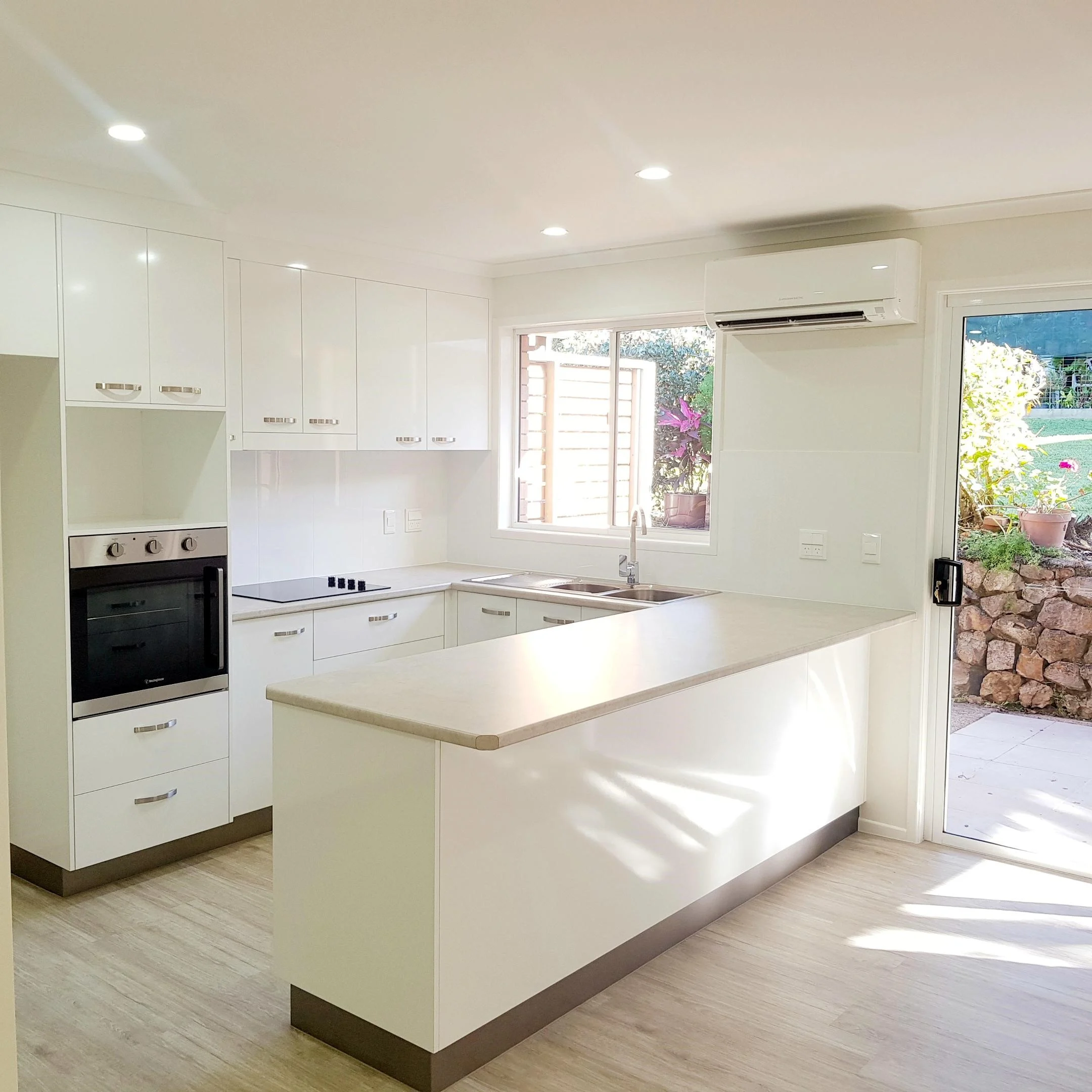 Spacious kitchen with modern finishes for easy low maintenance living.