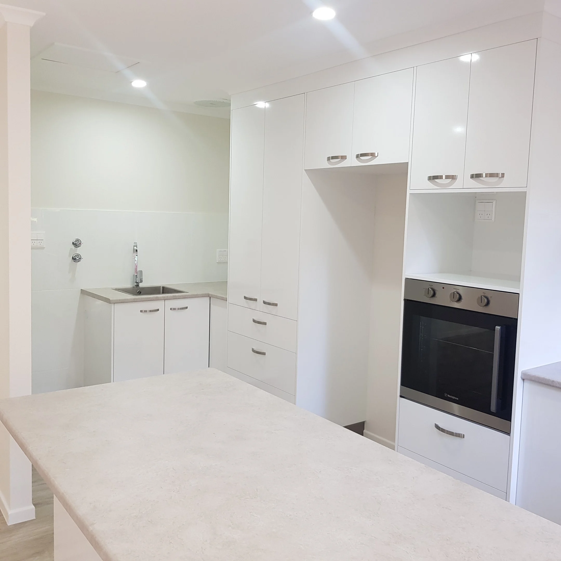Modern kitchen and laundry area in Unit 45, ideal for low maintenance living.