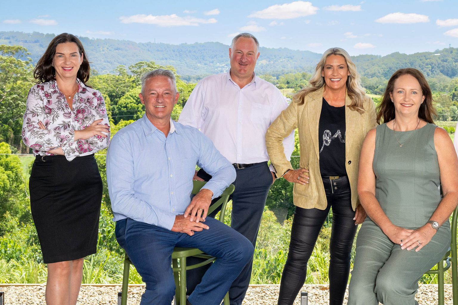 Sundale team promoting retirement communities and aged care services in scenic setting.