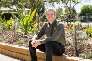 Coen Sundale's Maintenance and Grounds Manager, standing outdoors among landscaped gardens.